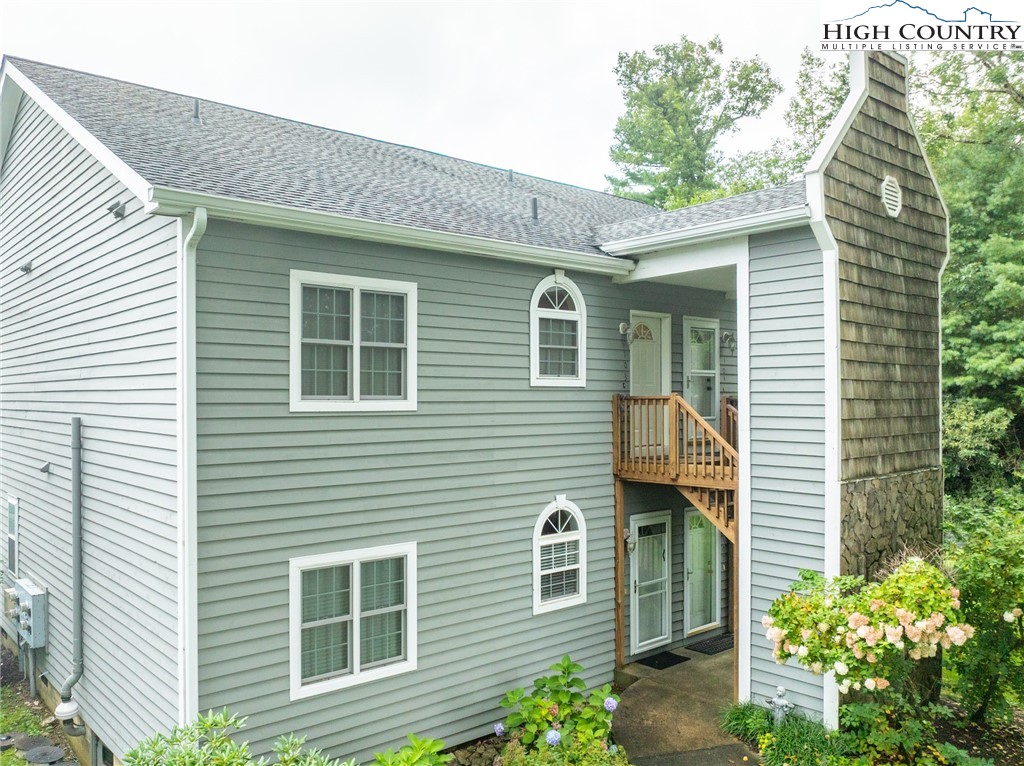 130 Prudden Lane, Unit 103 Blowing Rock, NC 28605 - Photo 4 of 36 a view of a house with a yard and potted plants