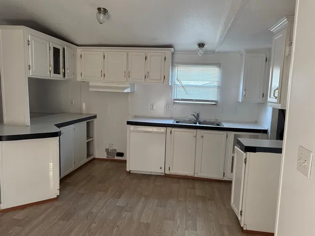 a view of a kitchen with a sink and cabinet area
