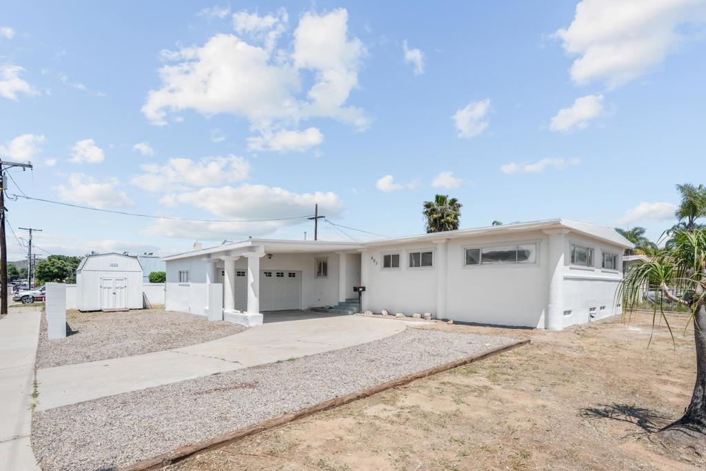 a large white building with trees in the background