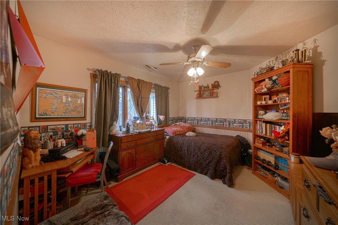 10000 Wisner Road Willoughby, OH 44094 - Photo 26 of 32 Carpeted bedroom featuring ceiling fan and a textured ceiling