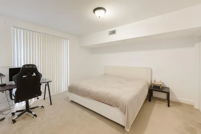 a bedroom with a bed and a desk