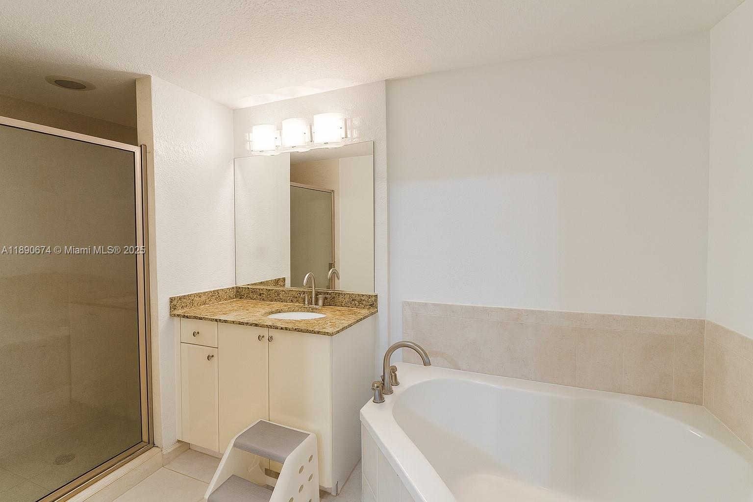 1830 Radius Drive, Unit 308 Hollywood, FL 33020 - Photo 13 of 31 a bathroom with a granite countertop sink and a bathtub