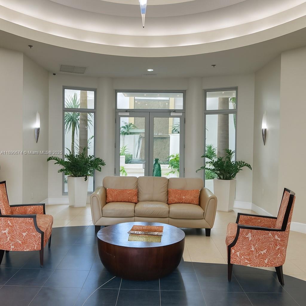 1830 Radius Drive, Unit 308 Hollywood, FL 33020 - Photo 20 of 31 a living room with furniture and a potted plant