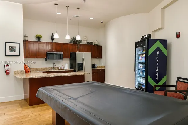 a kitchen with stainless steel appliances a refrigerator and a stove top oven