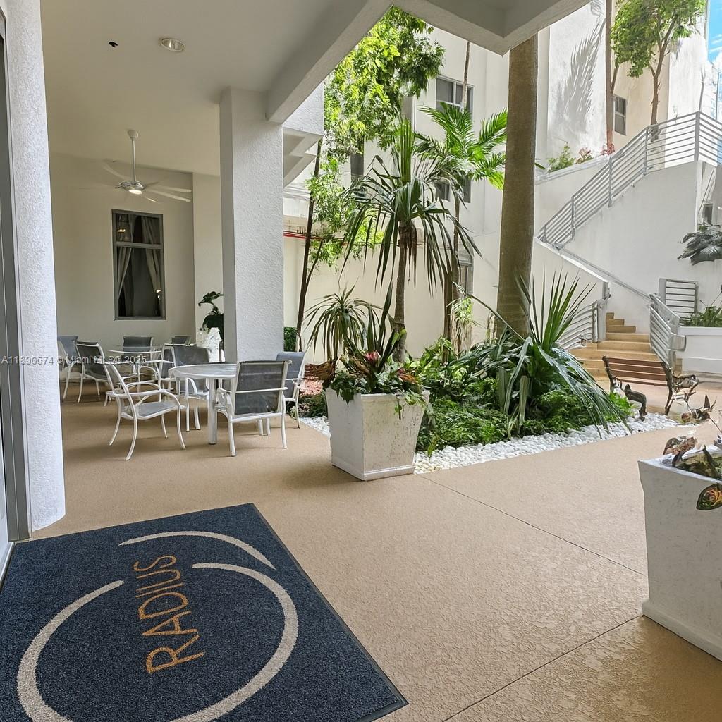 1830 Radius Drive, Unit 308 Hollywood, FL 33020 - Photo 25 of 31 a dining room with furniture and a potted plant