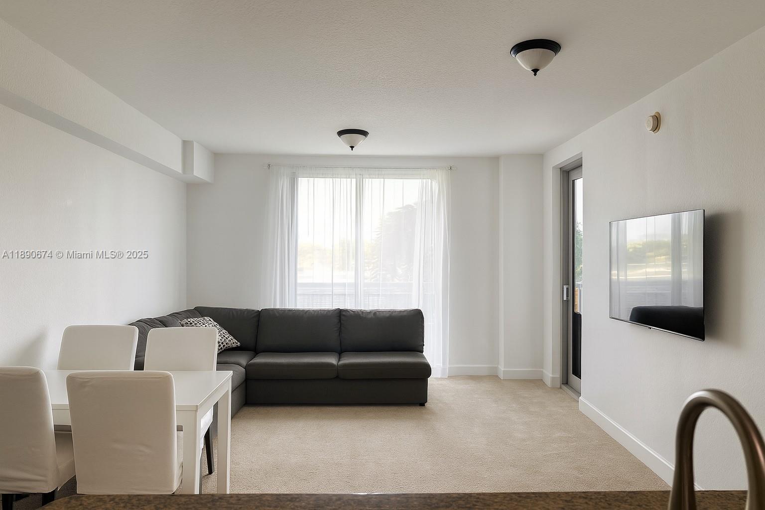 1830 Radius Drive, Unit 308 Hollywood, FL 33020 - Photo 3 of 31 a living room with furniture and a flat screen tv