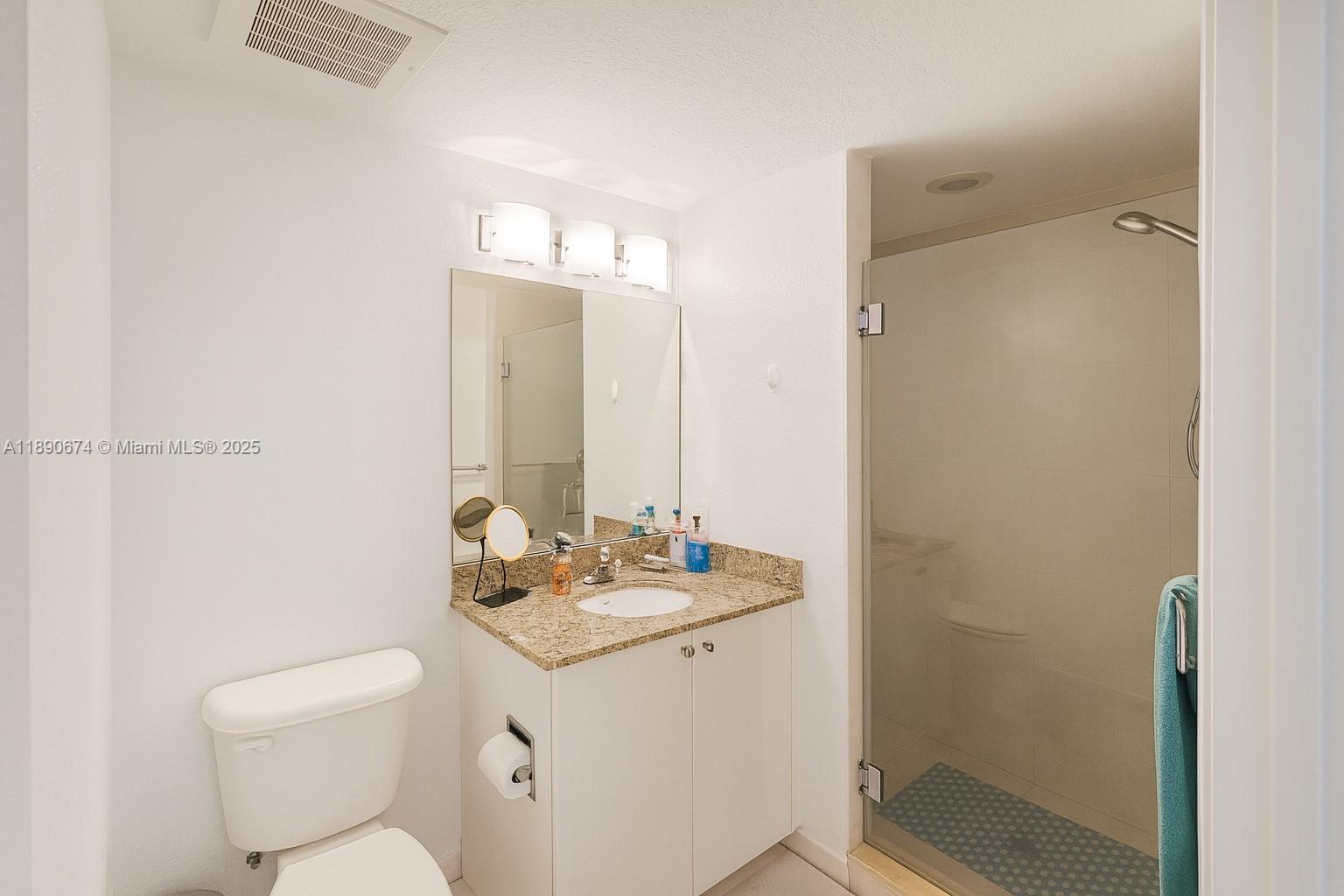 1830 Radius Drive, Unit 308 Hollywood, FL 33020 - Photo 8 of 31 a bathroom with a granite countertop sink toilet a mirror and shower