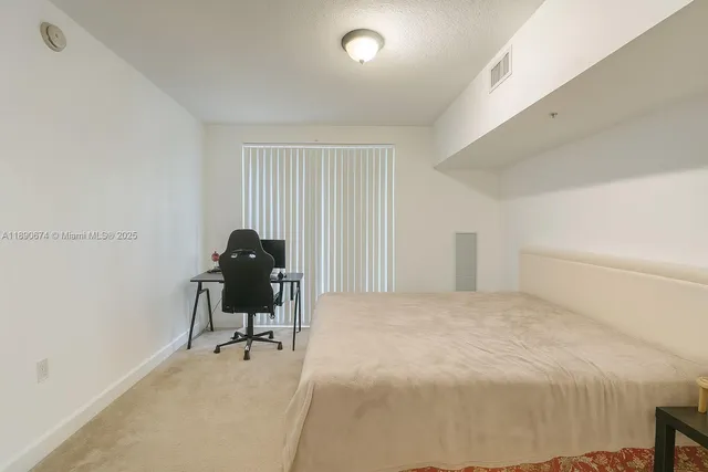 a bedroom with a workspace