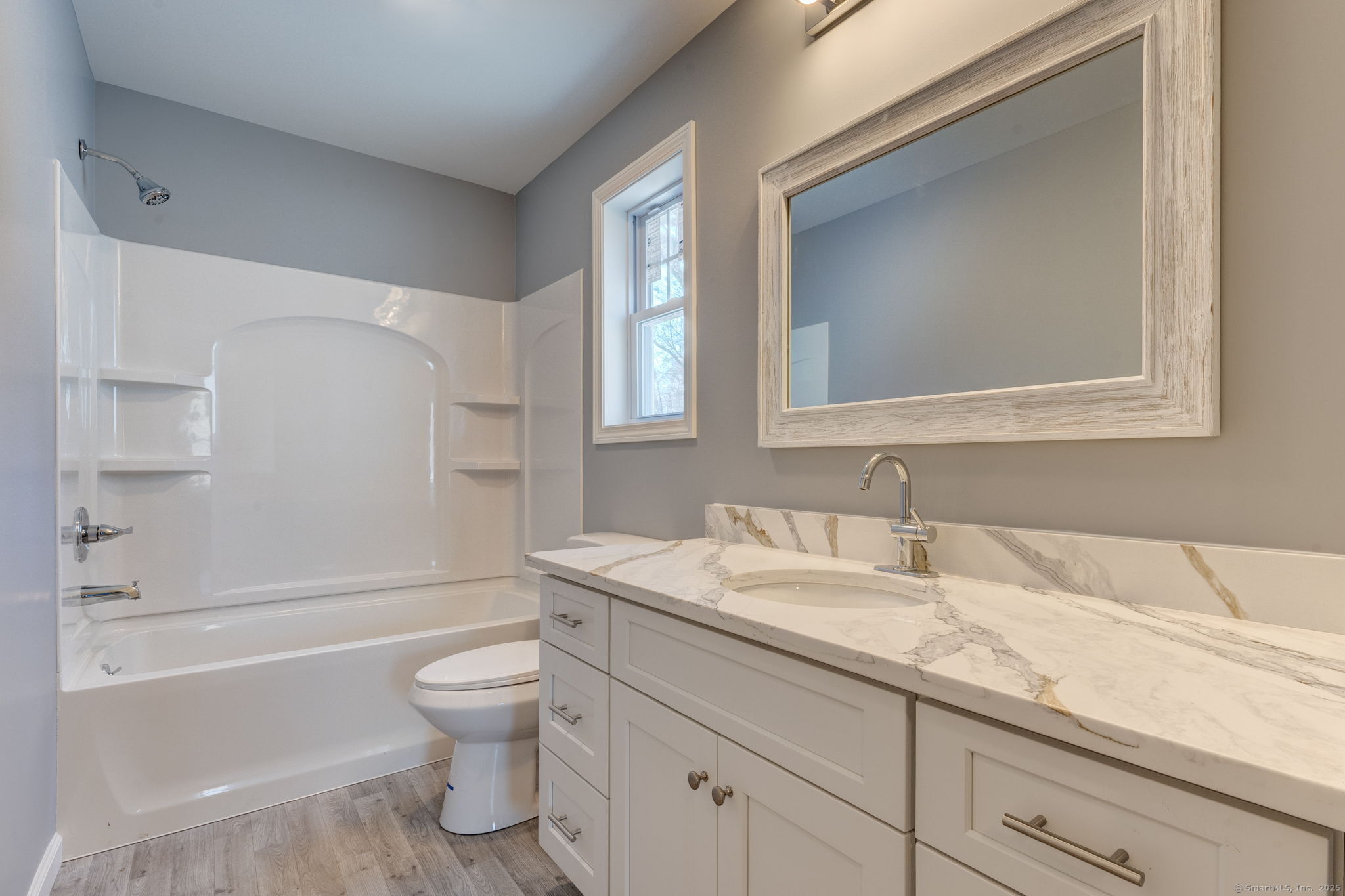 685 Wormwood Hill Road Mansfield, CT 06268 - Photo 11 of 13 a bathroom with a granite countertop toilet a sink and a bathtub