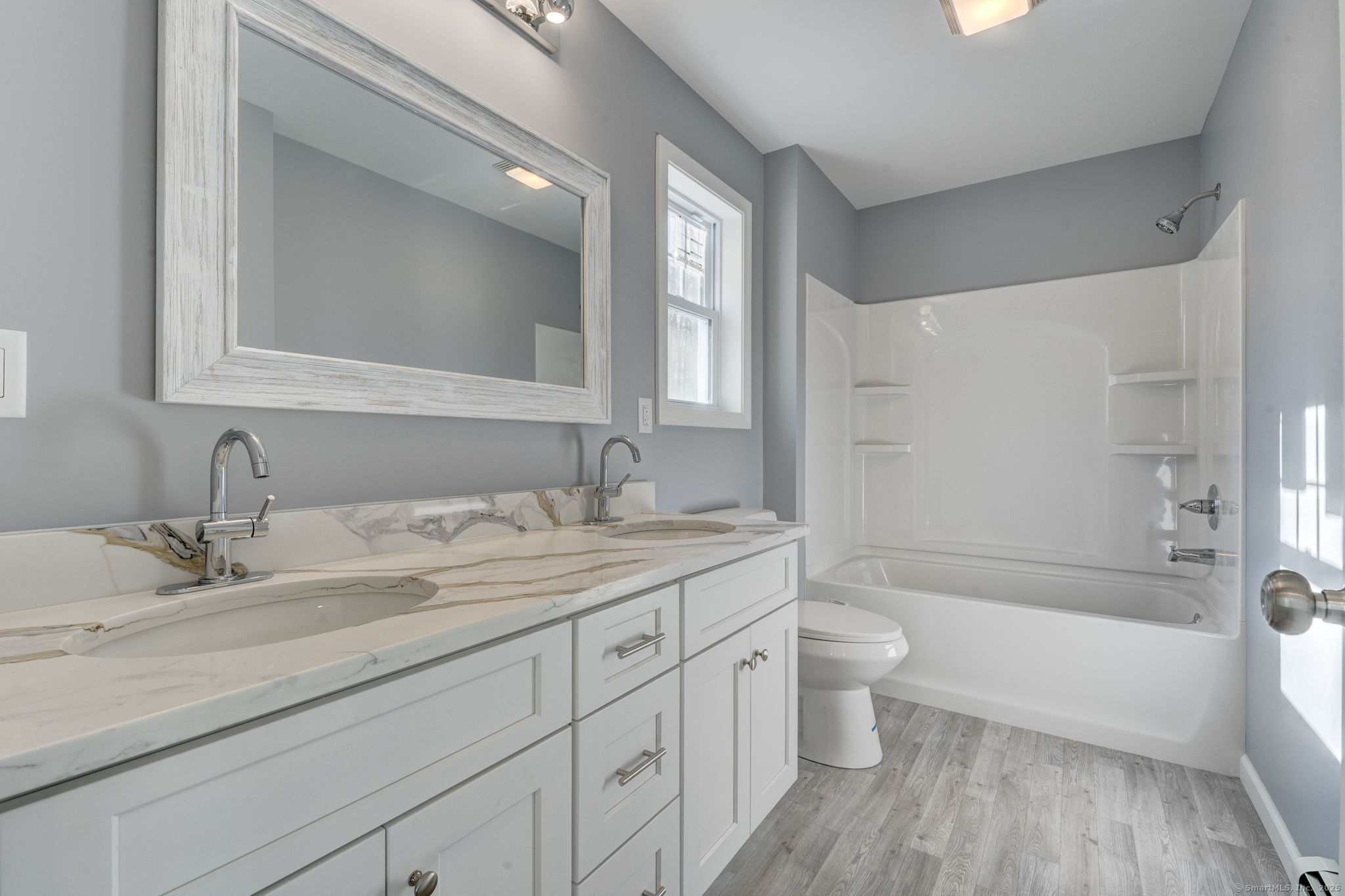 685 Wormwood Hill Road Mansfield, CT 06268 - Photo 12 of 13 a bathroom with a granite countertop sink a toilet and a large mirror