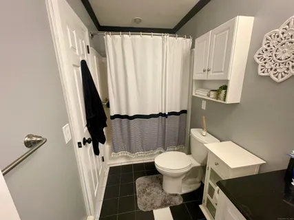 a white toilet sitting next to a small sink