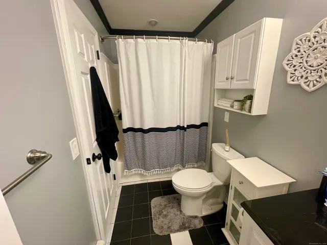 a white toilet sitting next to a small sink