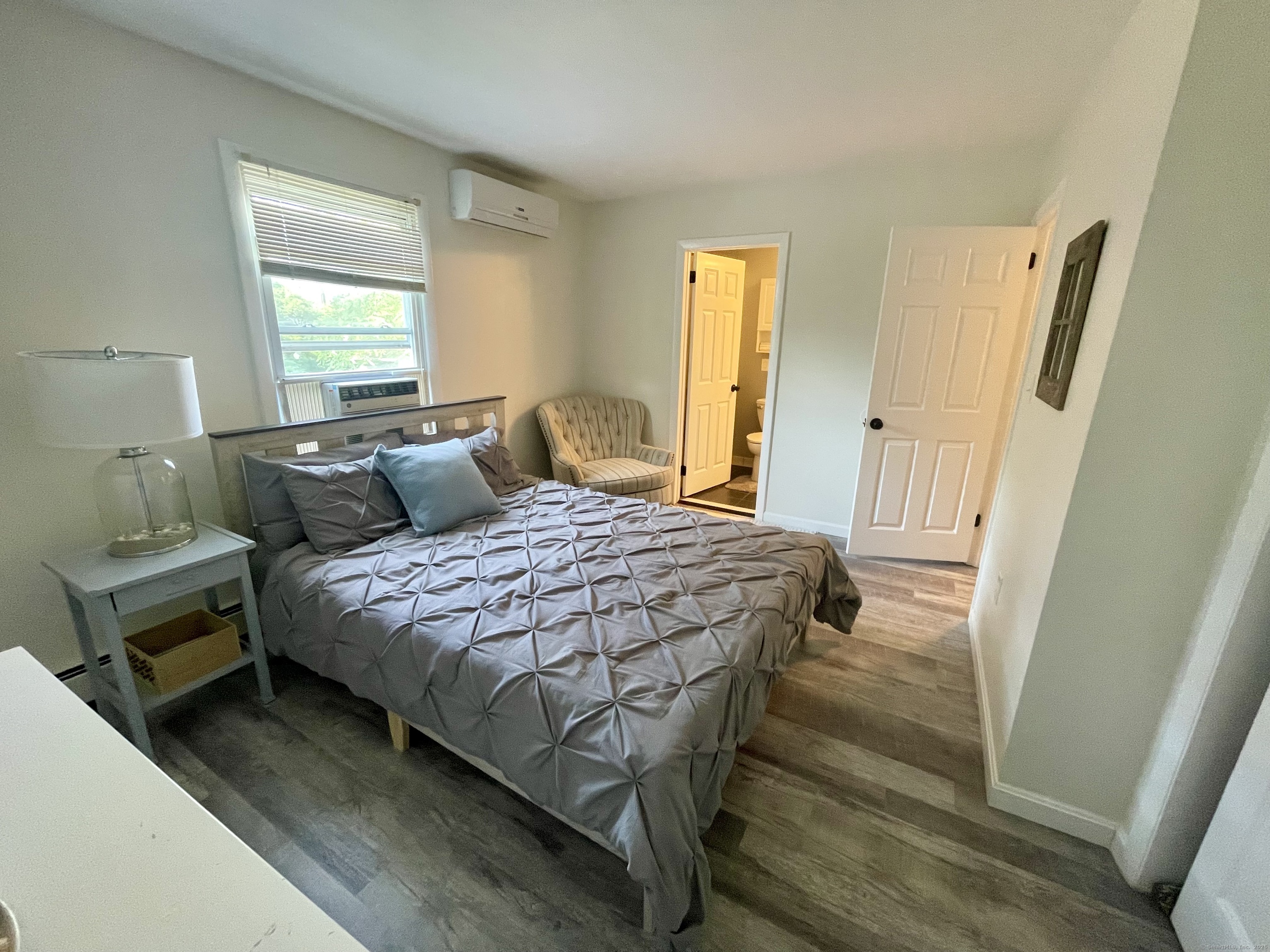 223 Seneca Drive Groton, CT 06340 - Photo 12 of 27 a bedroom with a bed and wooden floor