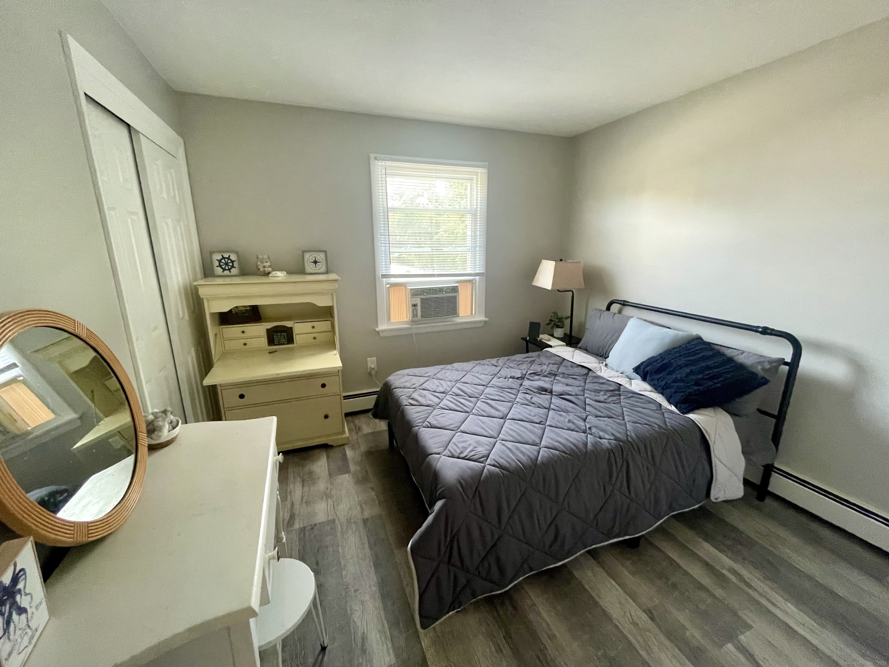 223 Seneca Drive Groton, CT 06340 - Photo 13 of 27 a bedroom with a bed and wooden floor