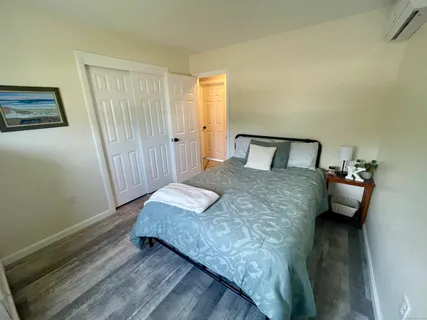 a bedroom with a bed and wooden floor