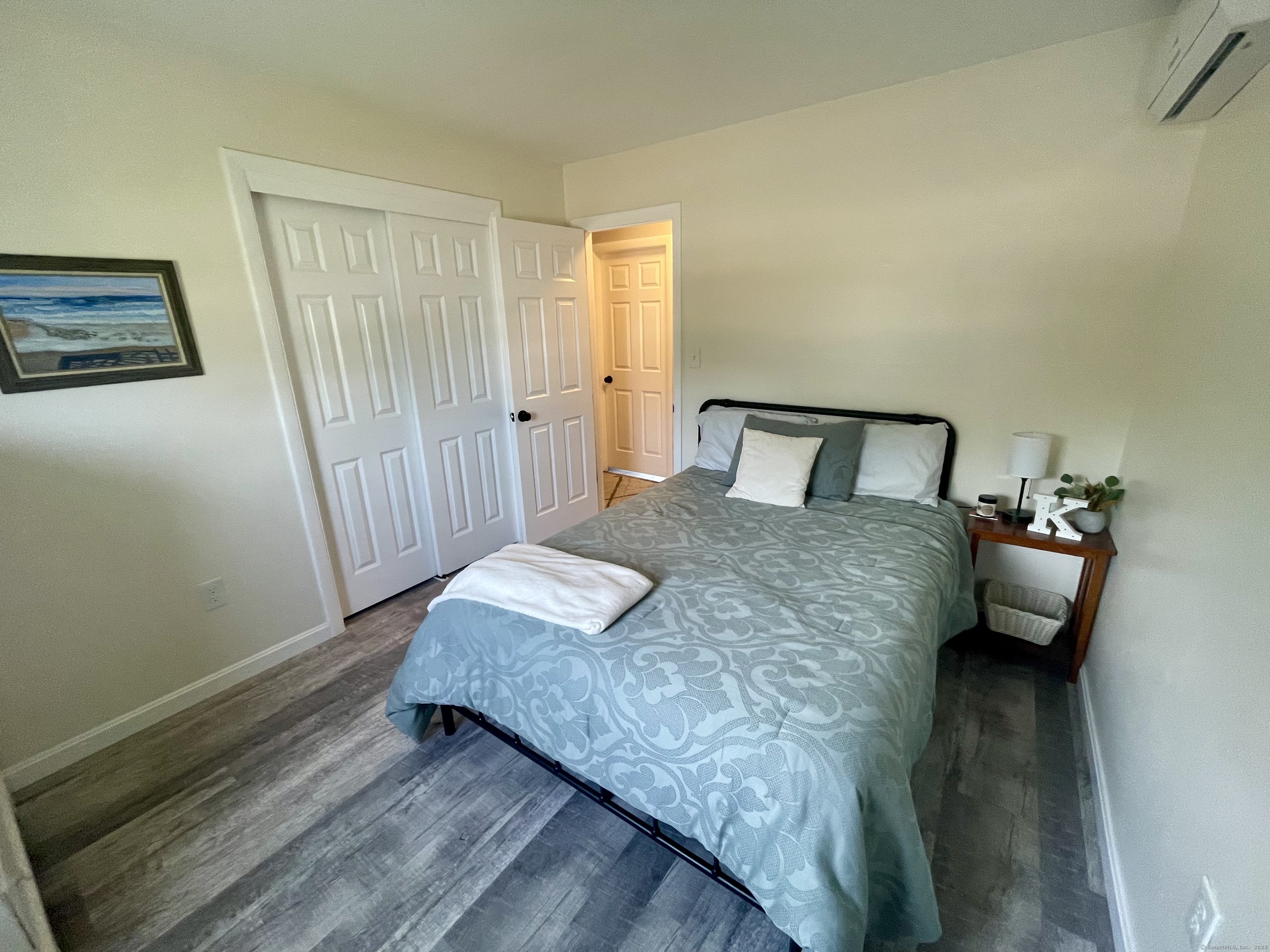 223 Seneca Drive Groton, CT 06340 - Photo 15 of 27 a bedroom with a bed and wooden floor