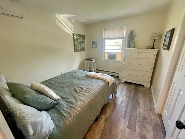 a bed sitting in a bedroom next to a window