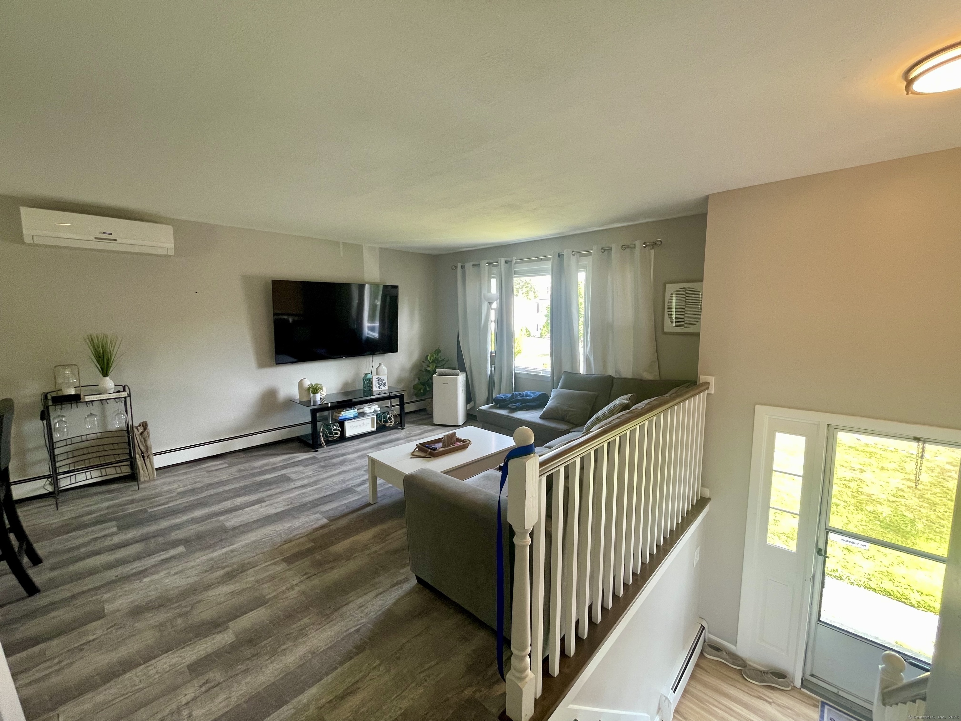 223 Seneca Drive Groton, CT 06340 - Photo 17 of 27 a living room with furniture and a flat screen tv