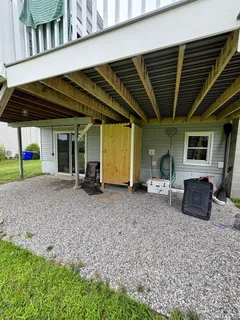 a backyard of a house with barbeque oven table and chairs