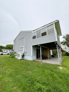 a view of a house with backyard and porch