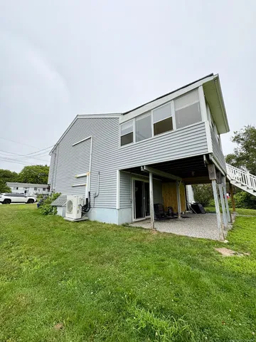 a view of a house with backyard and porch