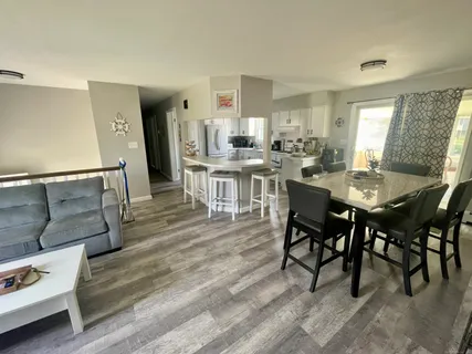 a dining room with furniture and wooden floor
