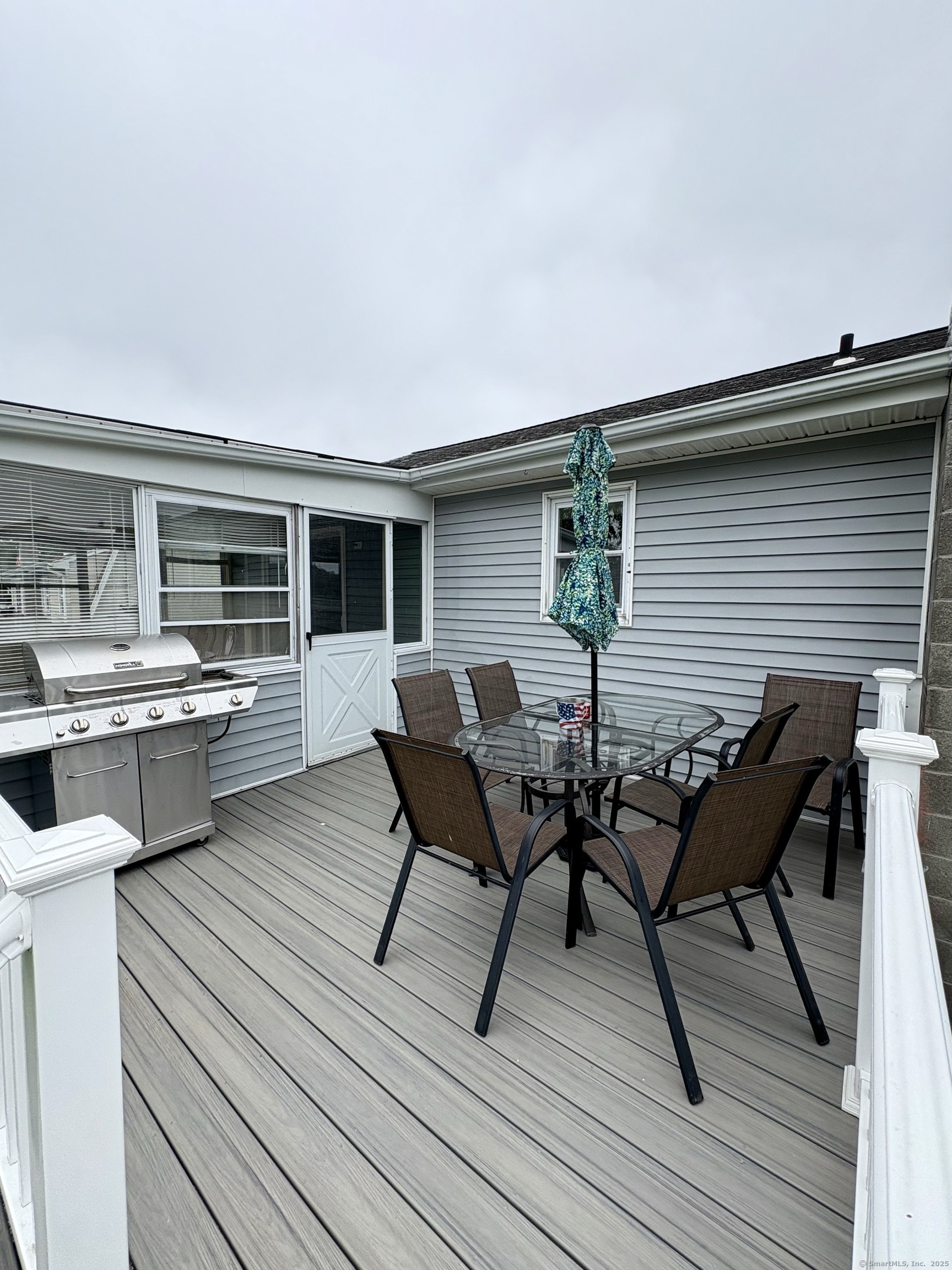 223 Seneca Drive Groton, CT 06340 - Photo 10 of 27 a view of a roof deck with table and chairs couches with wooden floor