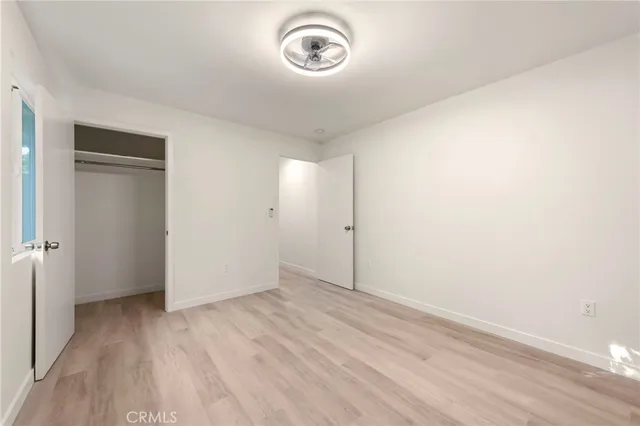 a view of room with hardwood floor and window