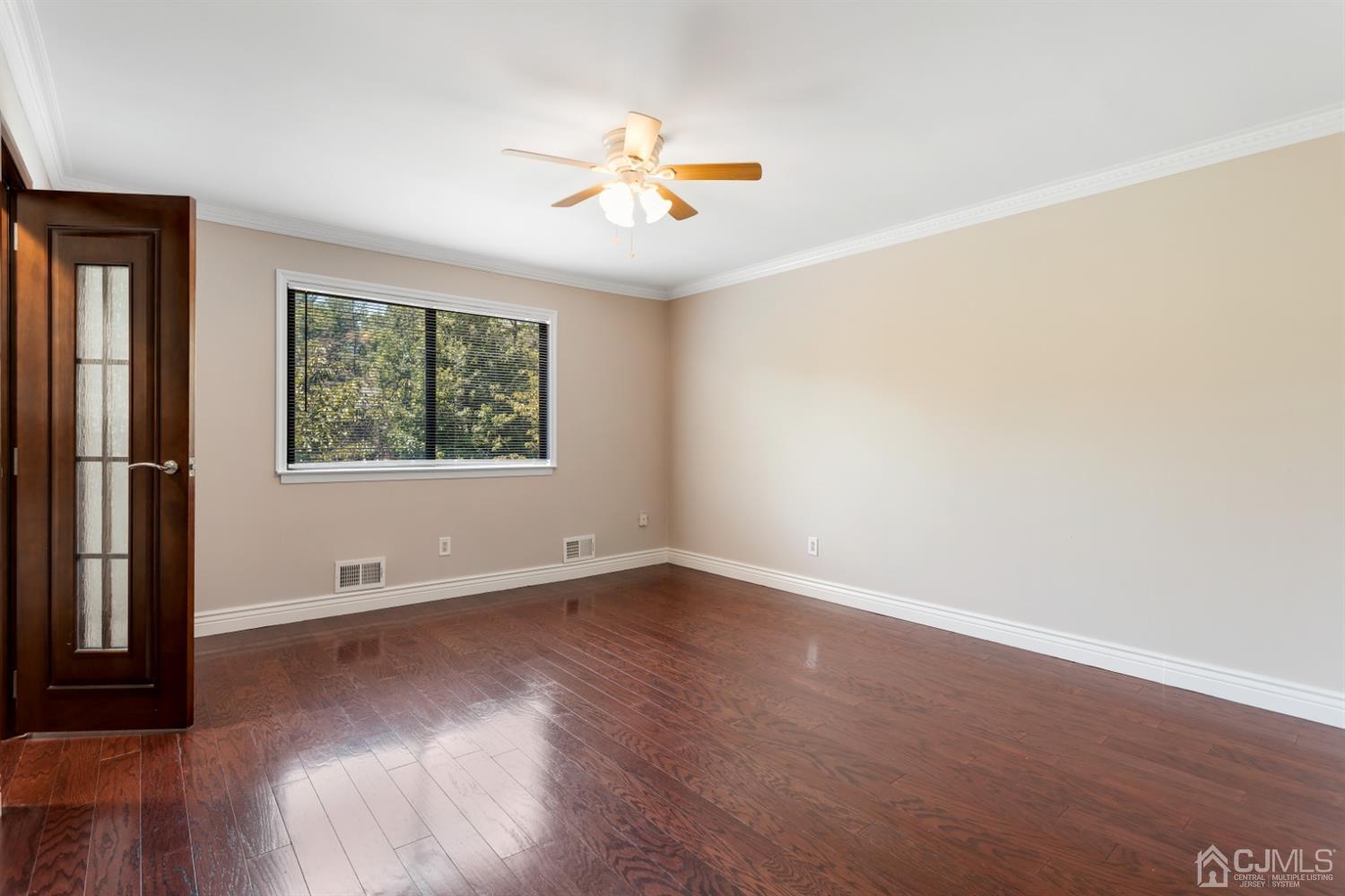 28 Arrowsmith Court Old Bridge, NJ 07747 - Photo 11 of 30 an empty room with wooden floor and windows