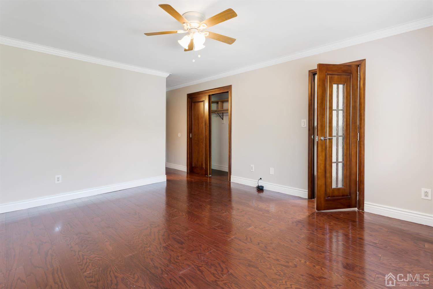 28 Arrowsmith Court Old Bridge, NJ 07747 - Photo 12 of 30 an empty room with wooden floor and door