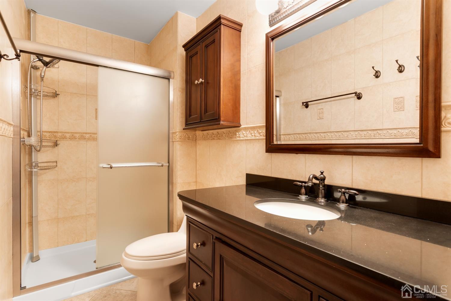 28 Arrowsmith Court Old Bridge, NJ 07747 - Photo 14 of 30 a bathroom with a granite countertop sink toilet and shower