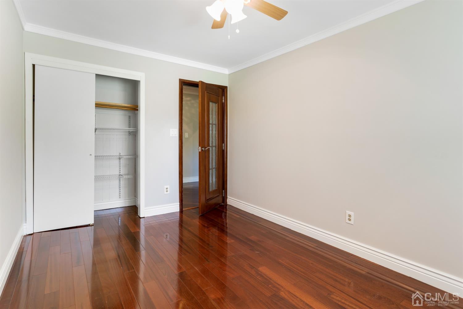 28 Arrowsmith Court Old Bridge, NJ 07747 - Photo 16 of 30 a view of an empty room with window and wooden floor
