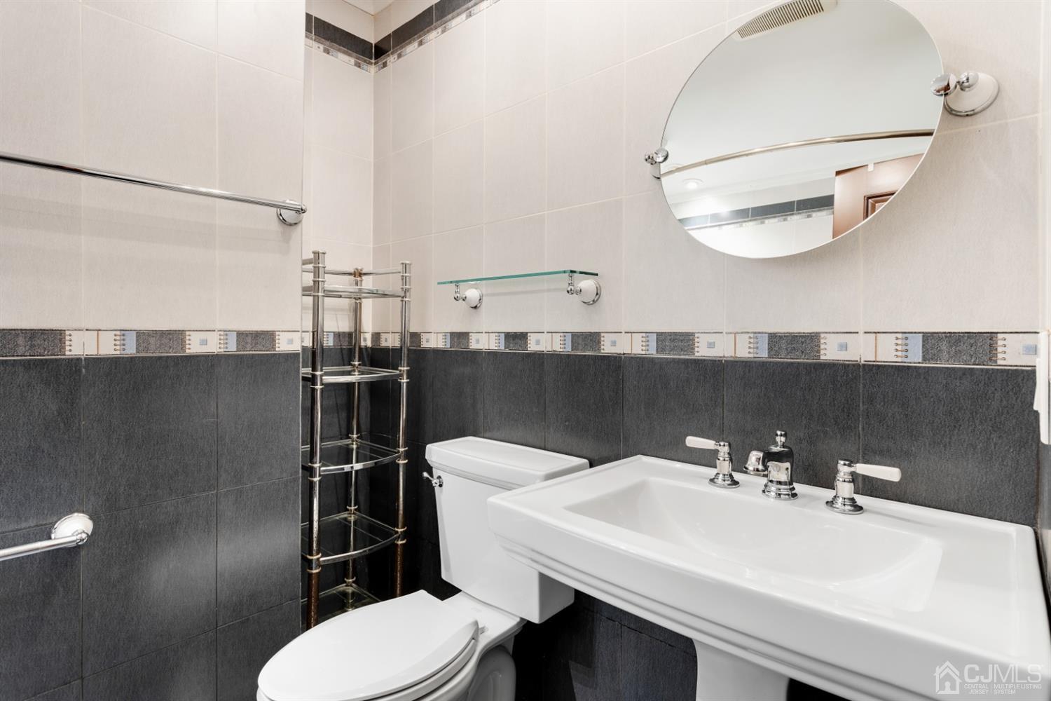 28 Arrowsmith Court Old Bridge, NJ 07747 - Photo 17 of 30 a bathroom with a sink mirror and toilet