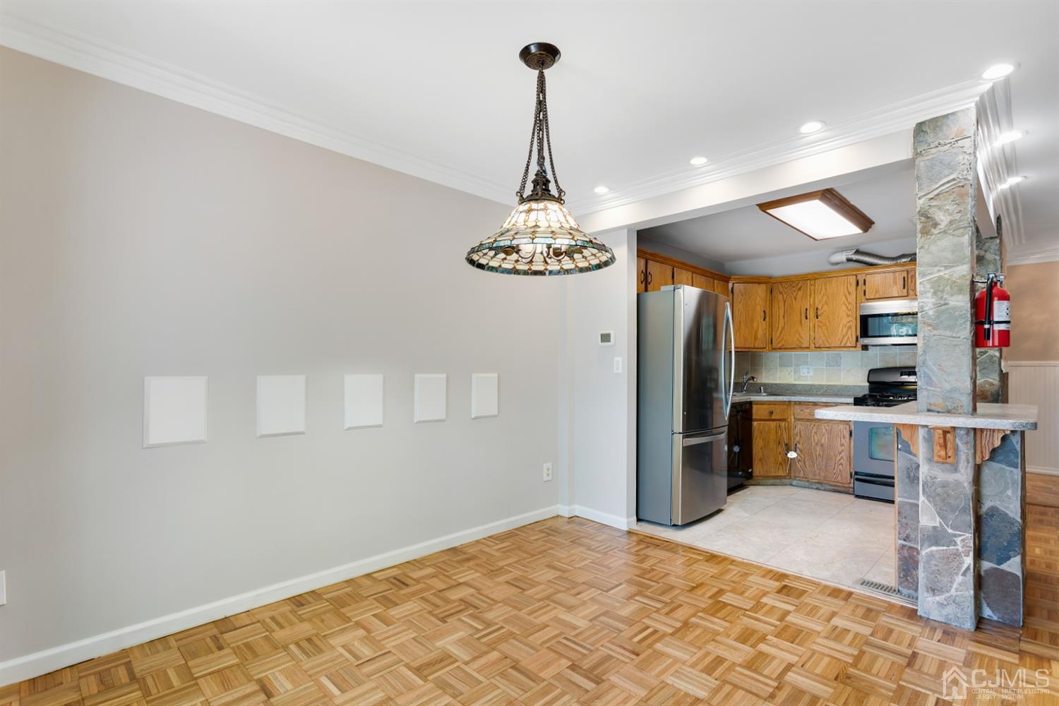 28 Arrowsmith Court Old Bridge, NJ 07747 - Photo 6 of 30 a kitchen with stainless steel appliances granite countertop a refrigerator a stove and a wooden floors