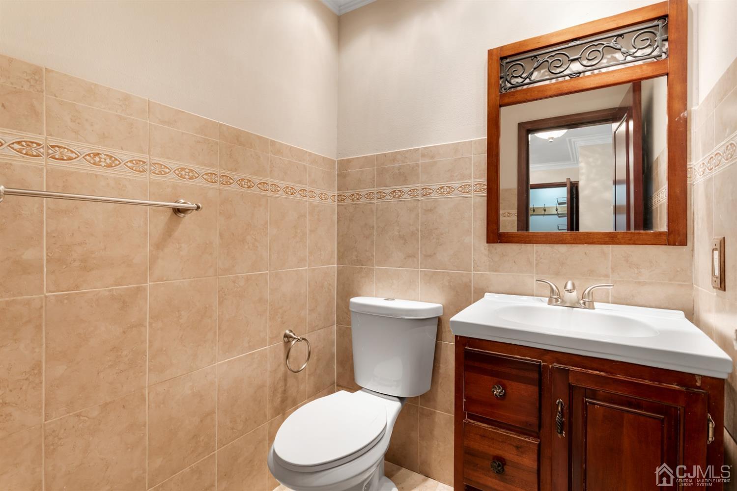28 Arrowsmith Court Old Bridge, NJ 07747 - Photo 10 of 30 a bathroom with a toilet a sink a mirror and vanity