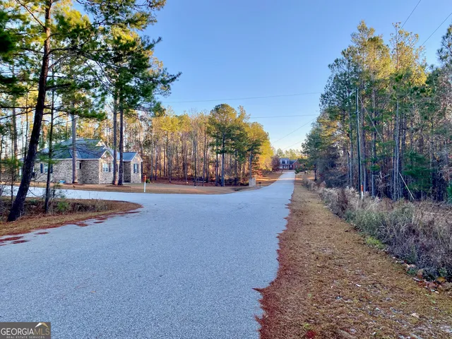 a view of a street with trees on both side of it