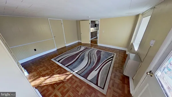 a view of an empty room with wooden floor