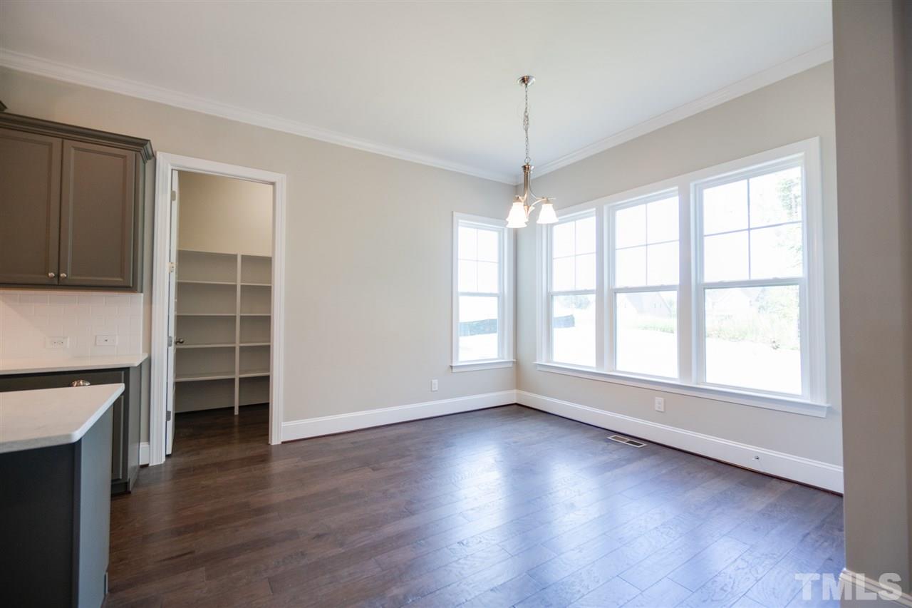 520 Adkins Ridge Road Rolesville, NC 27571 - Photo 11 of 25 an empty room with wooden floor and windows