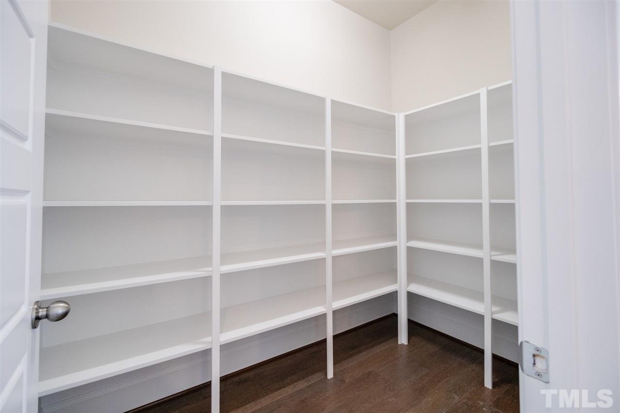 520 Adkins Ridge Road Rolesville, NC 27571 - Photo 12 of 25 a view of walk in closet with empty racks