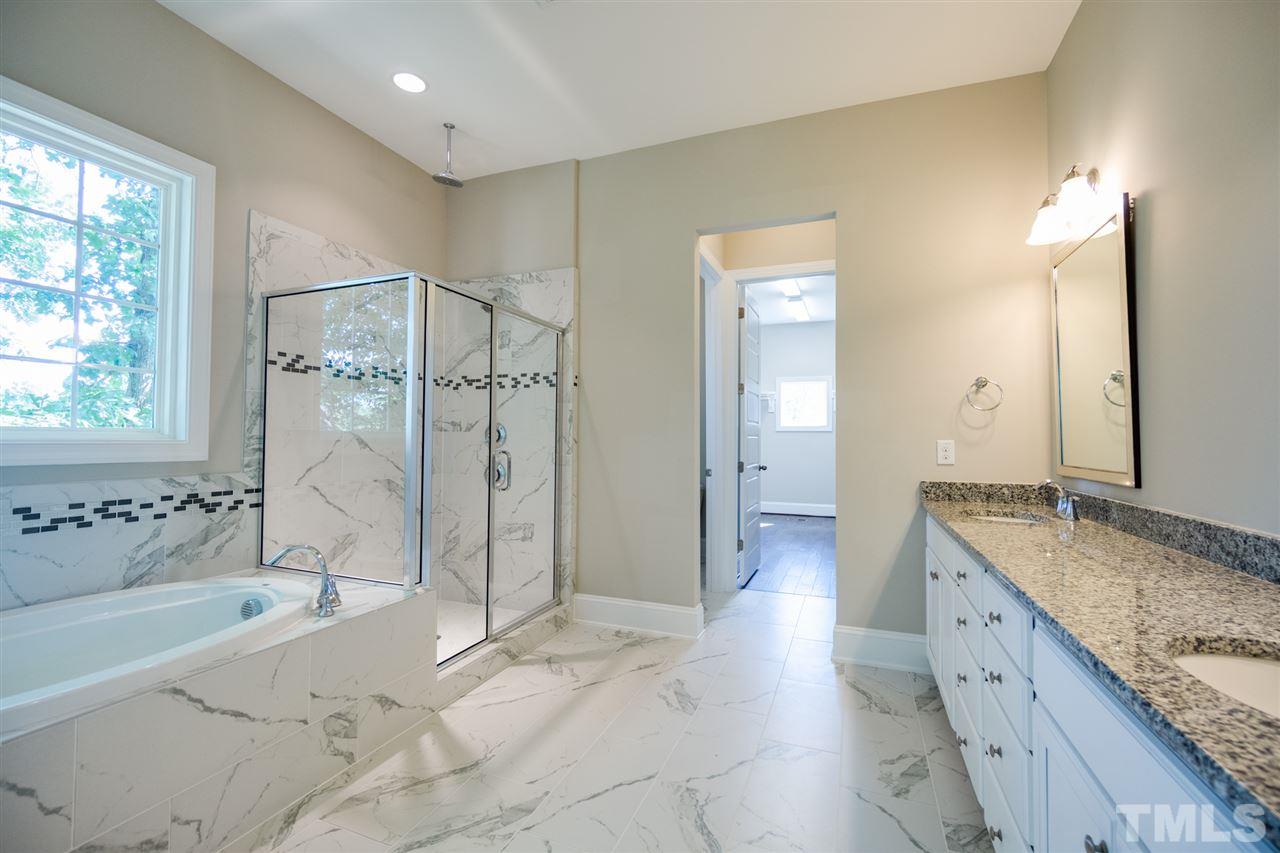 520 Adkins Ridge Road Rolesville, NC 27571 - Photo 14 of 25 a spacious bathroom with a granite countertop tub sink and mirror