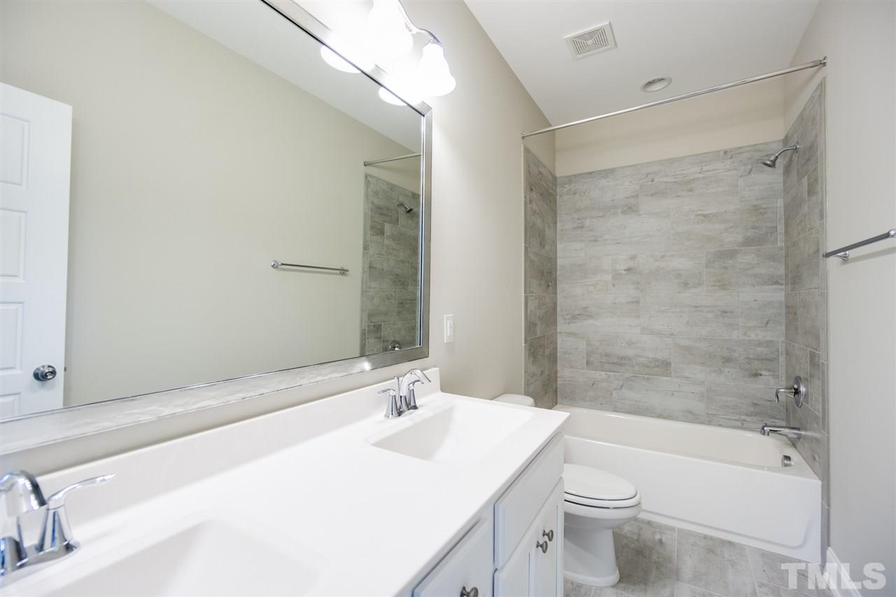 520 Adkins Ridge Road Rolesville, NC 27571 - Photo 17 of 25 a bathroom with a sink mirror toilet and bathtub