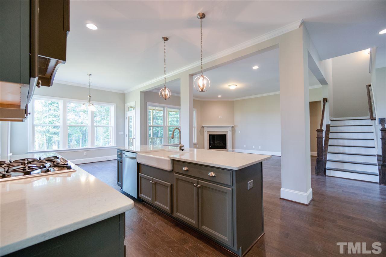 520 Adkins Ridge Road Rolesville, NC 27571 - Photo 6 of 25 a kitchen with a sink stove and wooden floor