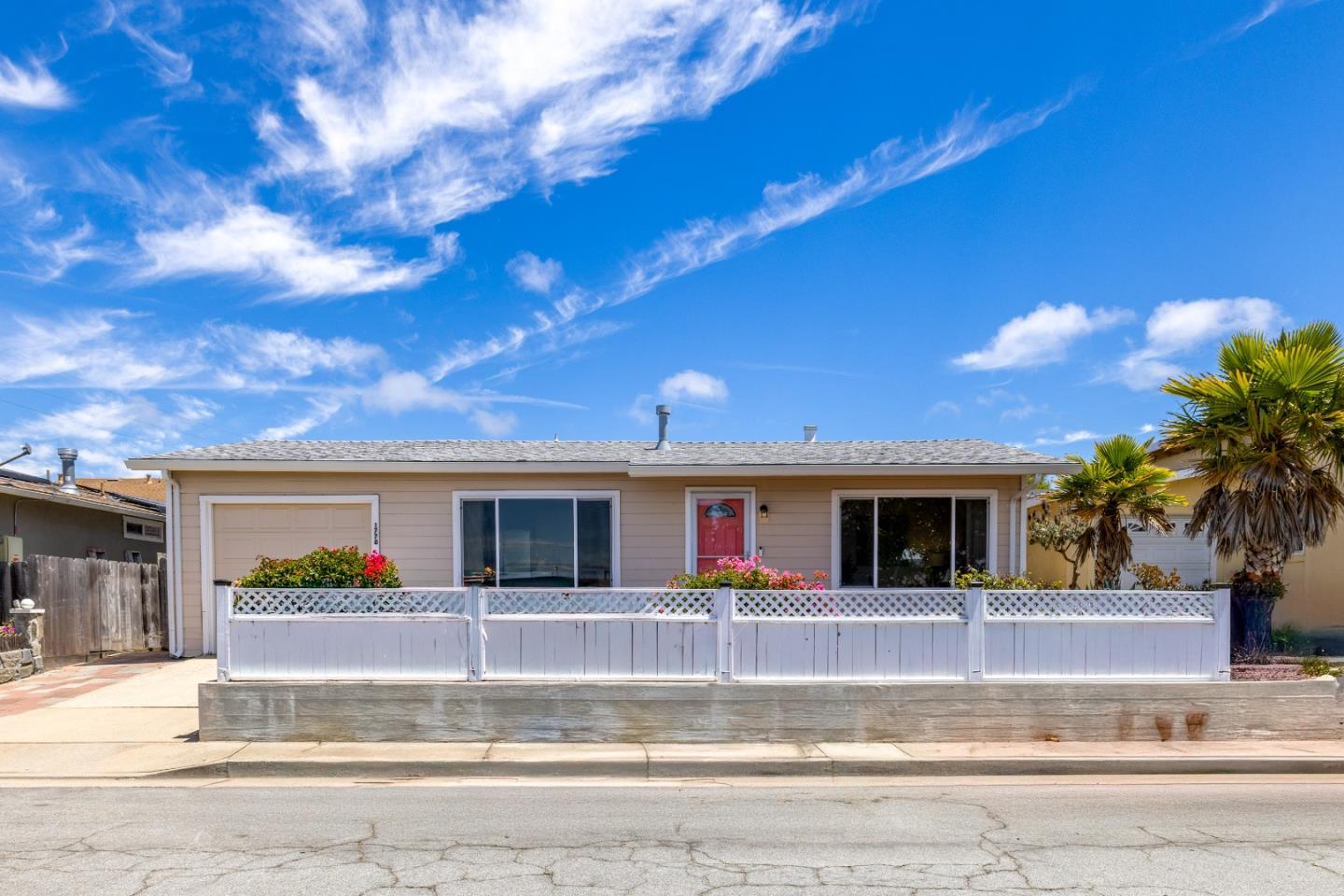 a view of yellow house with a large windows