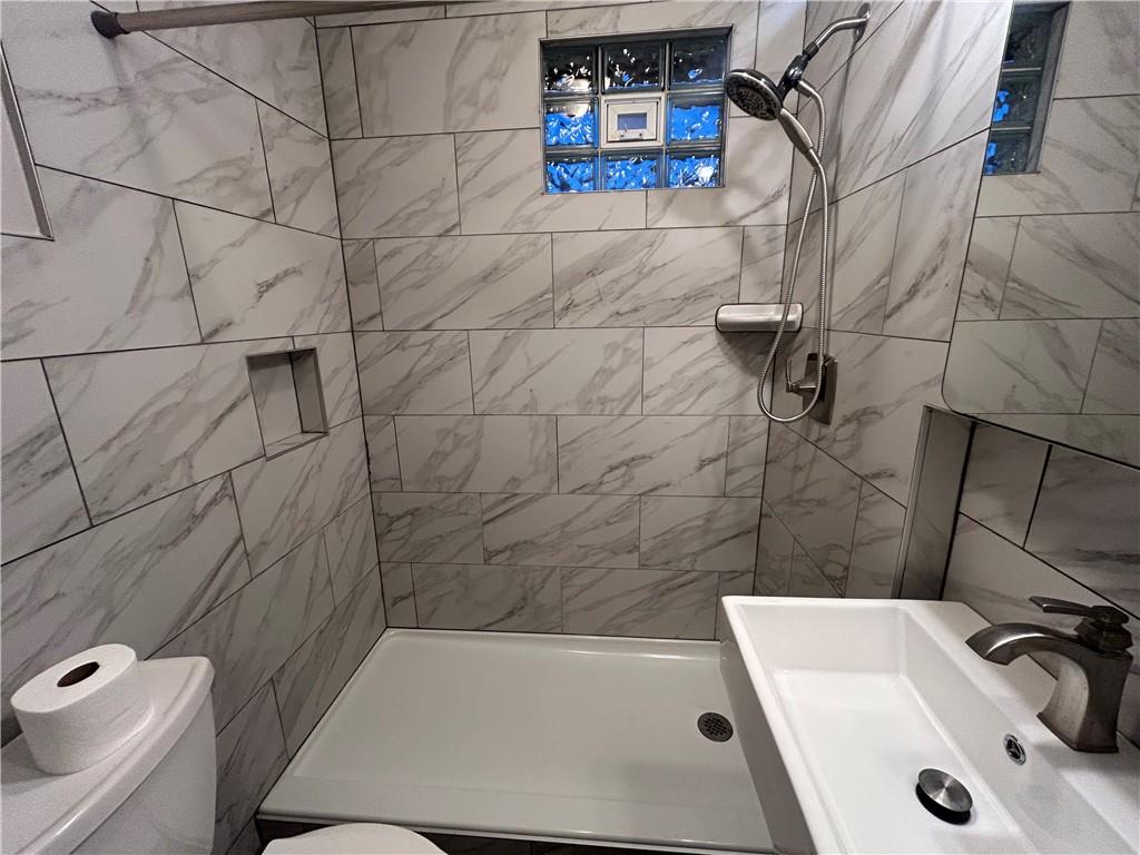 2225 Hampton Street Pittsburgh, PA 15218 - Photo 12 of 20 a bathroom with a sink a toilet and shower