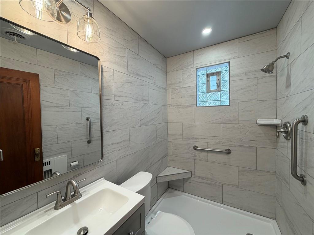 2225 Hampton Street Pittsburgh, PA 15218 - Photo 16 of 36 a bathroom with a sink toilet and shower