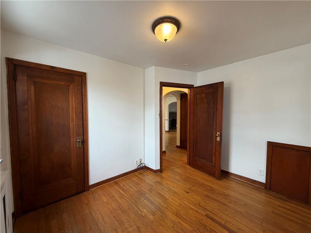 2225 Hampton Street Pittsburgh, PA 15218 - Photo 19 of 36 an empty room with wooden floor and windows