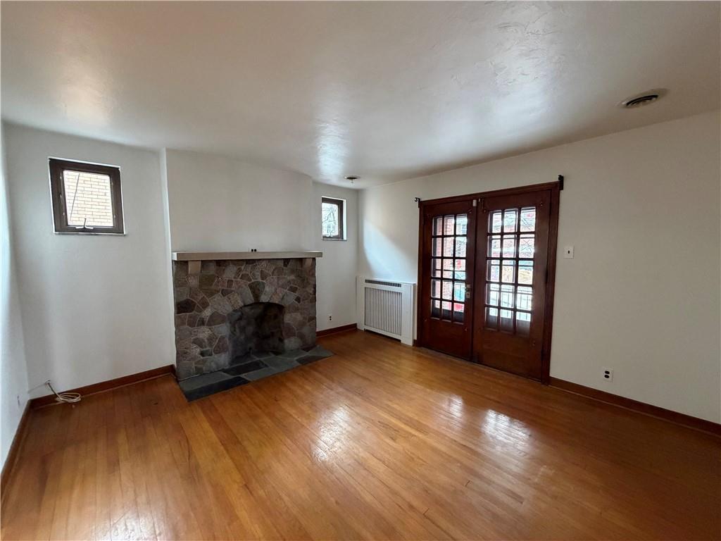 2225 Hampton Street Pittsburgh, PA 15218 - Photo 7 of 36 an empty room with windows and fireplace