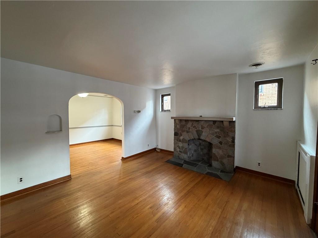 2225 Hampton Street Pittsburgh, PA 15218 - Photo 8 of 36 an empty room with wooden floor fireplace and windows