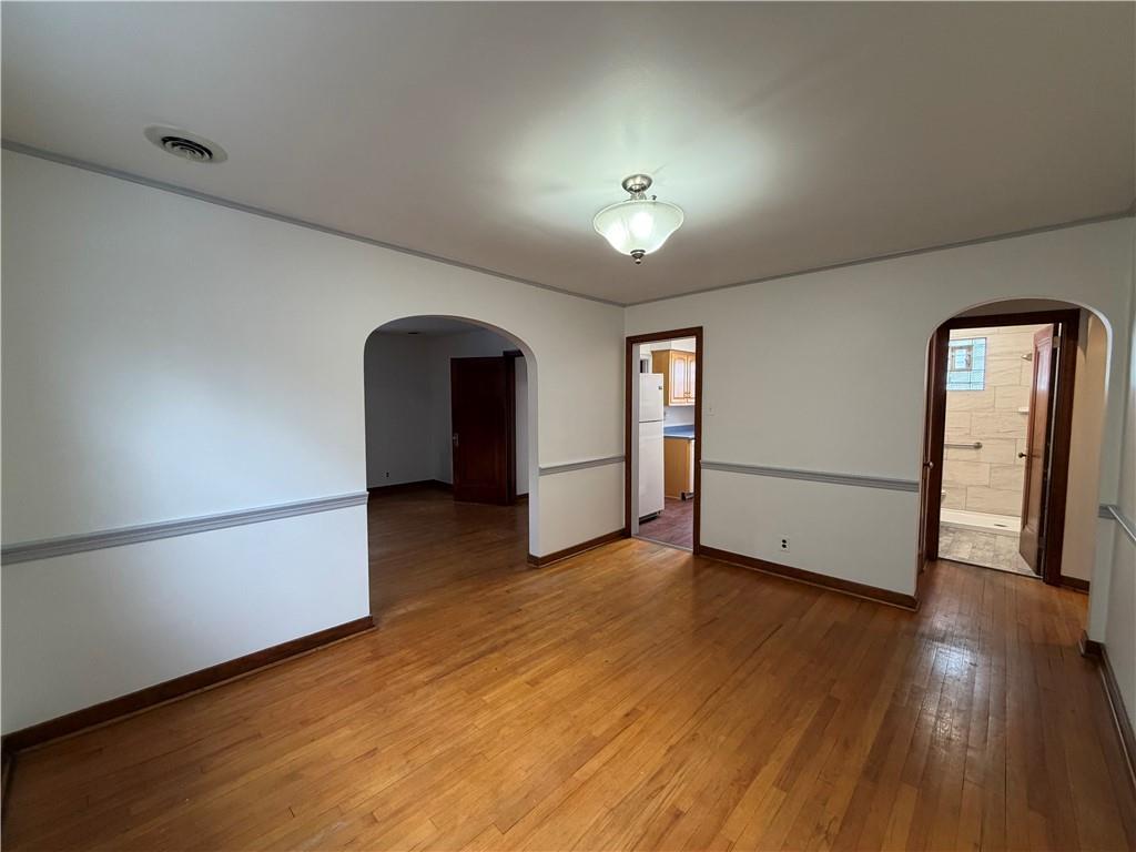 2225 Hampton Street Pittsburgh, PA 15218 - Photo 10 of 36 a view of an empty room with wooden floor and a window