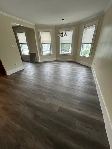 wooden floor in an empty room with windows